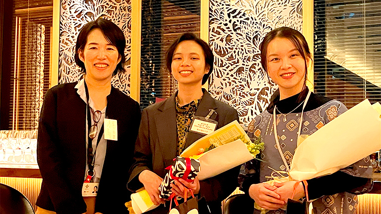 Presentation of a bouquet of flowers by GM Onda of Corporate Sustainability Div to graduates Ms.Marchia and Ms.Angel.
